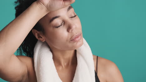 African-american-tired-woman-over-blue-background.