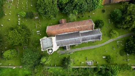 a fast top-down spinning shot of holy cross church in goodnestone