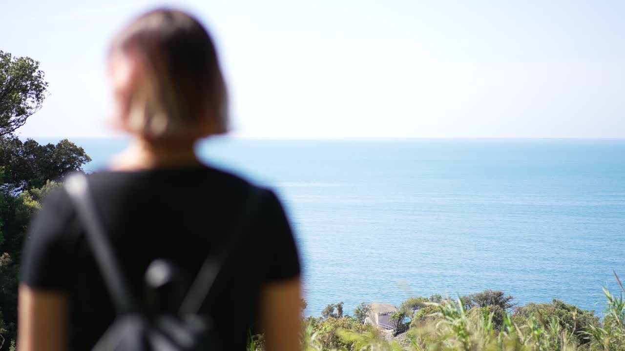 Girl looking at beautiful landscape of cinque terre, Italy.
