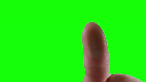 caucasian man pointing on green background