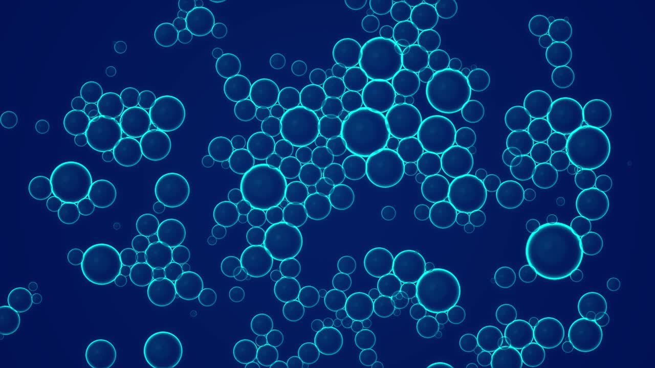 Oil blue drops moving in water. Abstract background. Macro shot of various air bubbles in water rising up on light blue background. Suspended spheres of air in oil rest on surface of water