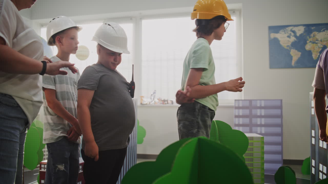 Female Teacher Organizing Creative Classroom Space with Cardboard Urban Models