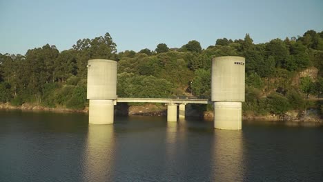 water pours through the sluice gates of the dam in the north of portugal