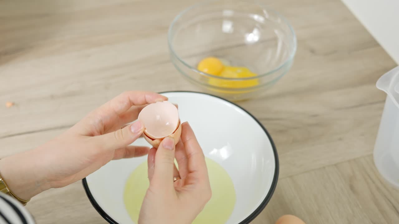 Separating egg whites from yolks as part of the preparation process for tiramisu dessert