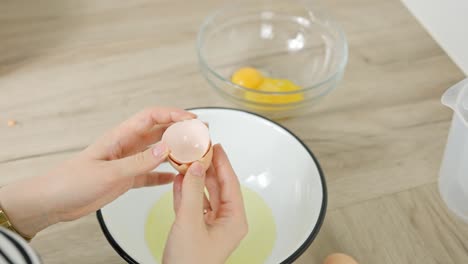 separating egg whites from yolks as part of the preparation process for tiramisu dessert