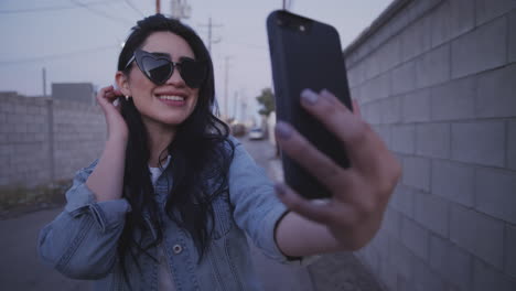 happy girl look herself through the phone.