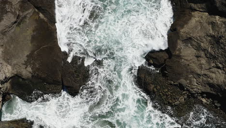 Descending-close-to-the-foamy-white-water-of-waves-crashing-onto-the-rocks