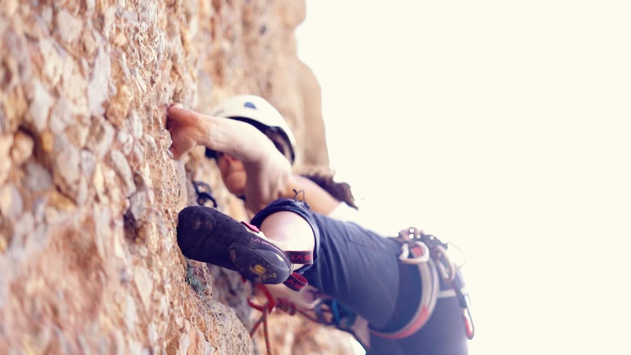Murcia, Spain, October 29, 2024: Sportsperson rock climbing in slow motion at a wall rock