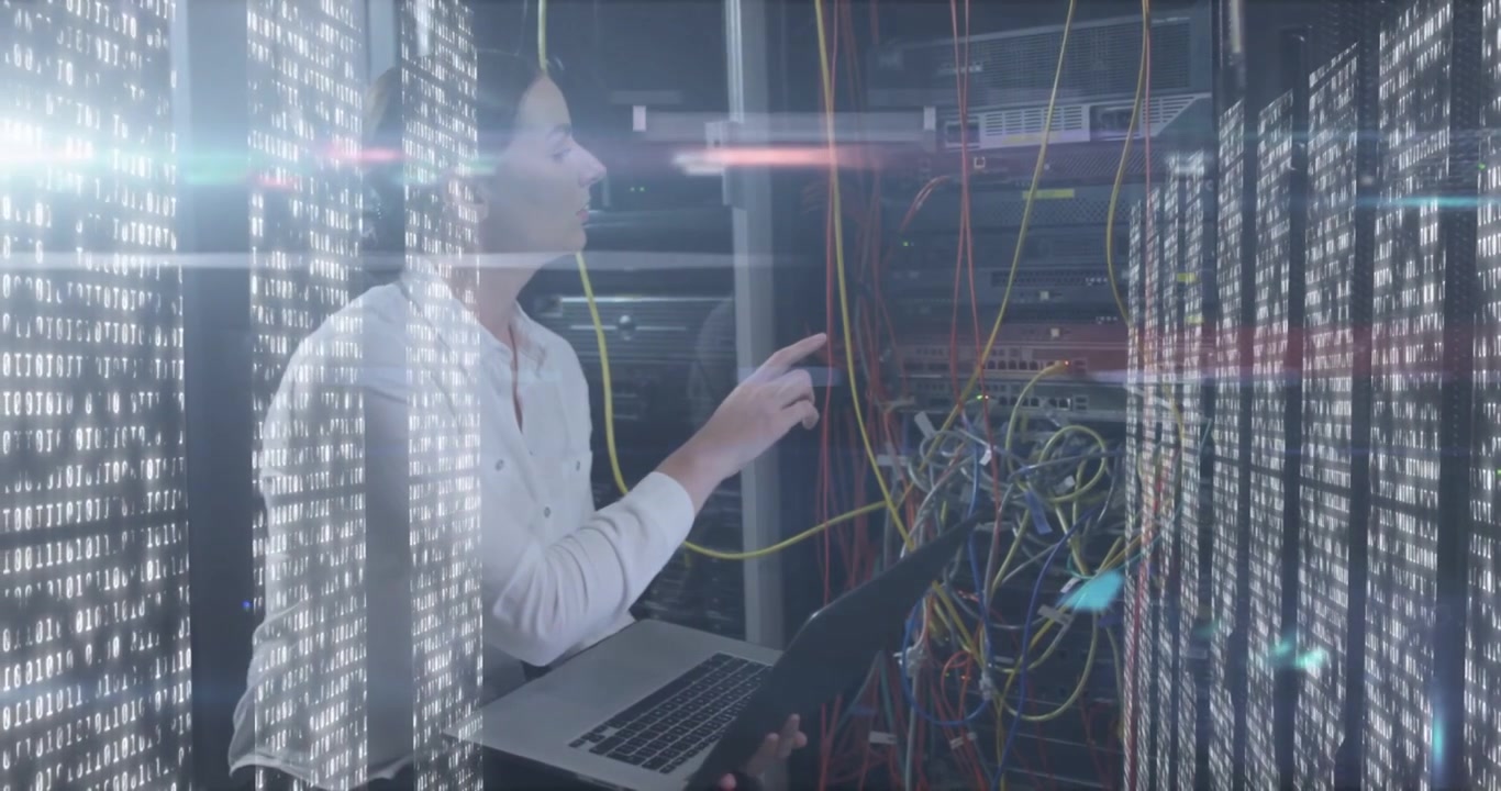 Vertical video: Alerting tech in white shirt testing datacenter ports with yellow cable, laptop
