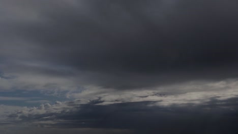 timelapse of approaching storm. blue skies into dark clouds with rain in the distance.
