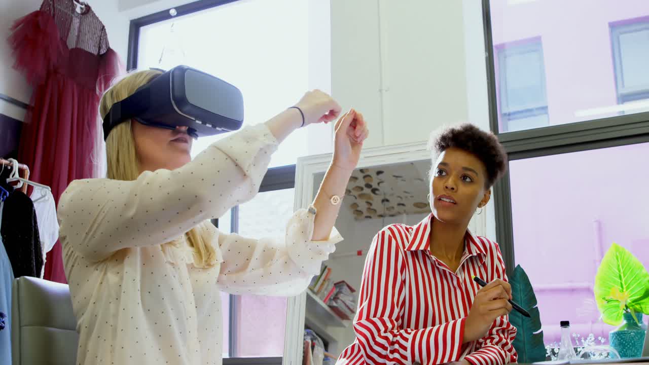 Fashion designers using virtual reality headset and graphic tablet 4k