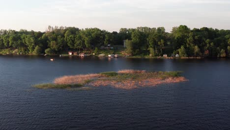 Aerial-low-flying-shot-across-a-blue-Midwestern-lake