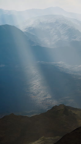 misty mountain range with sunbeams