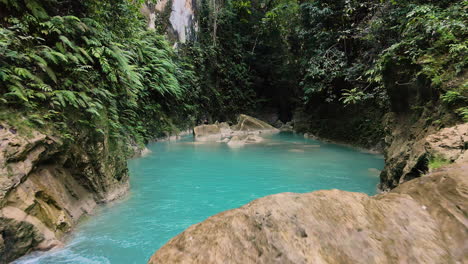 blue lagoon with crystal clear water in the jungle of sumba island, indonesia