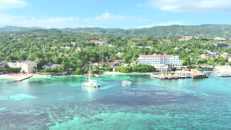 coast of jamaica, caribbean beautiful sea, drone shot. hotels and boats in the coast.