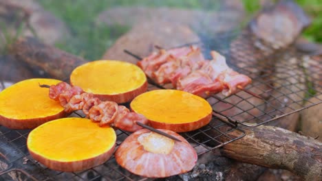 Close-up-grilling-pumpkin-chunks-and-squid-skewers-on-a-makeshift-rustic-barbecue