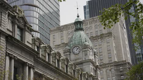 Close-up-of-Sinclair-Centre-shopping-mall-detailed-copper-cupola-with-clock-in-Downtown-Vancouver,-British-Columbia,-Canada