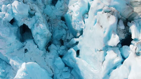 close-up tilt-down drone view of iceberg ridges in dawes glacier, endicott arm fjord, alaska