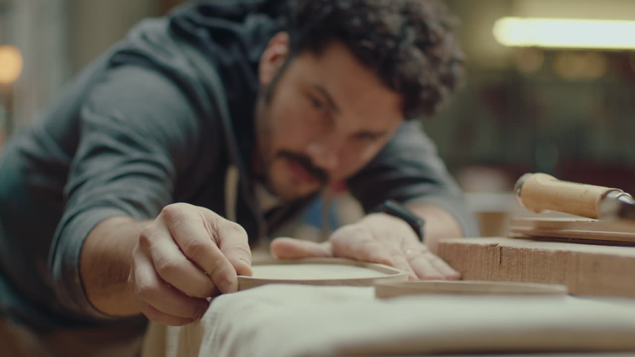 Artisan Checking Wooden Tray after Polishing in Workshop