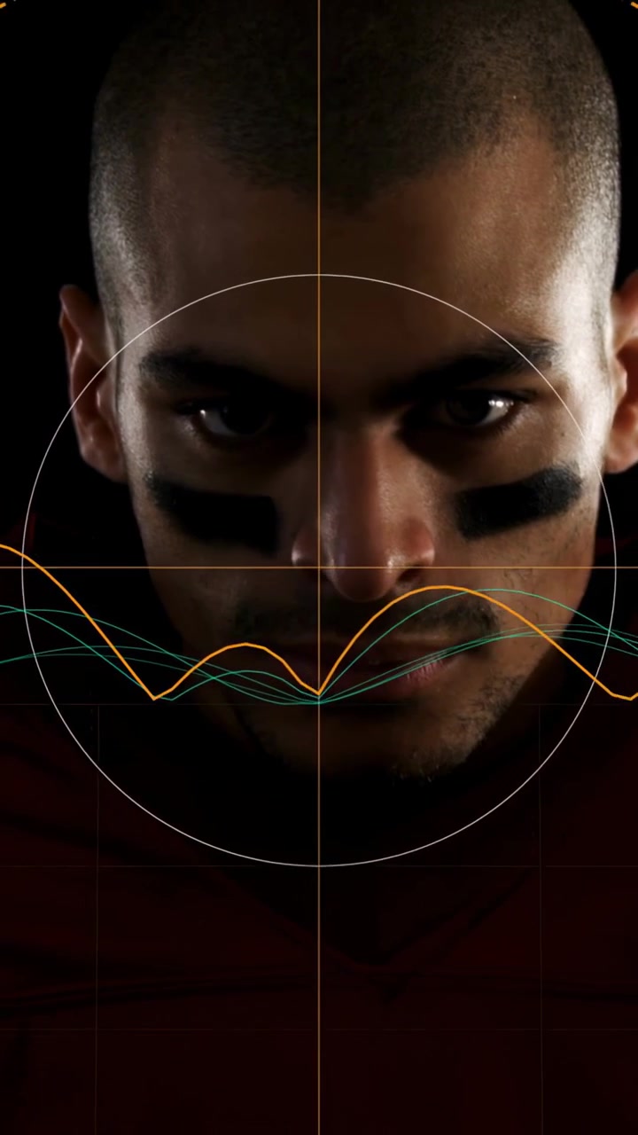 Vertical video: Man football player leaning forward waves football centering and HUD assessing gaze