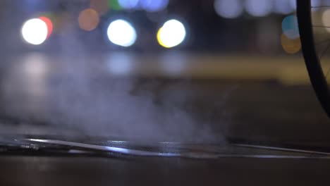 Steaming-storm-sewer-and-walking-people-at-night