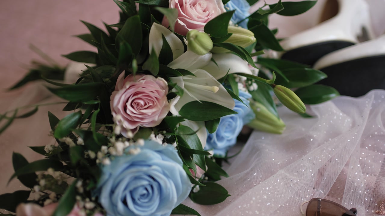 Close up of a wedding bouquet with pink roses and white lilies
