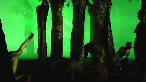 ethereal dance performance in a green-lit forest setting