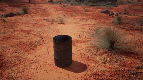 old empty rusted barrel on sand