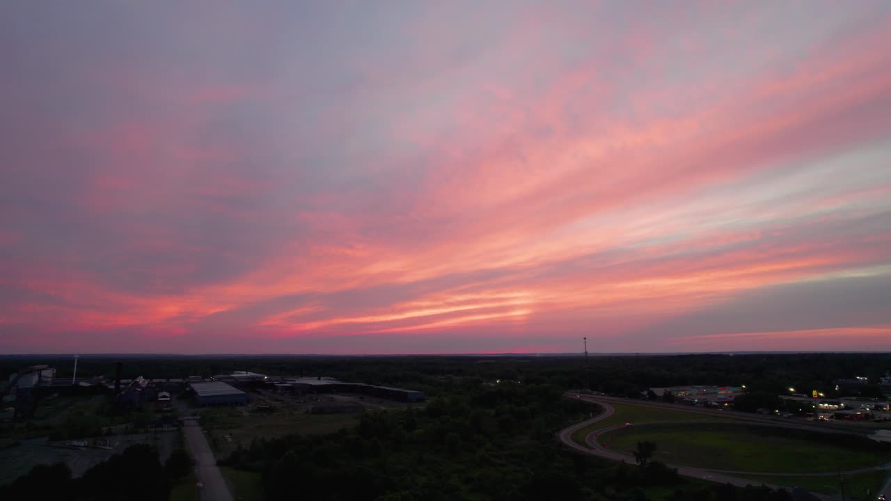 A real amazing panoramic view of a beautiful pink sky at sunset time with gentle colorful clouds. Long panorama