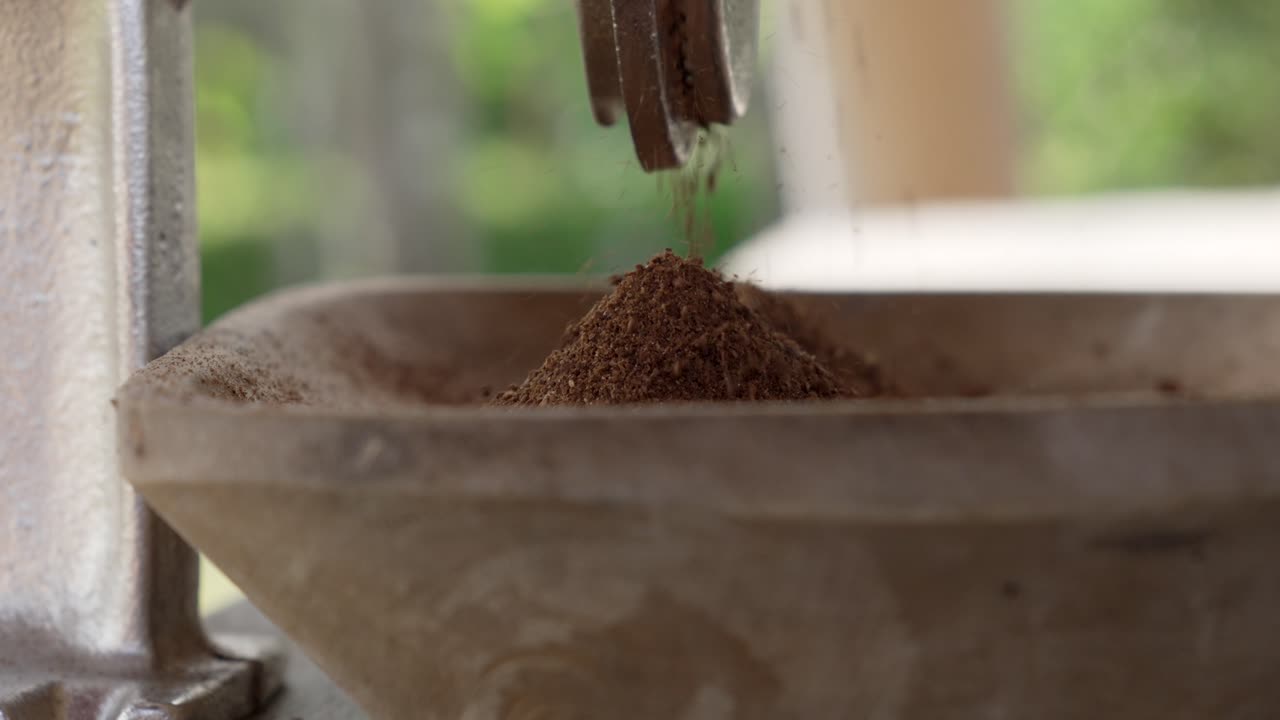 Up-close coffee beans grinding process South America robusta, how is made
