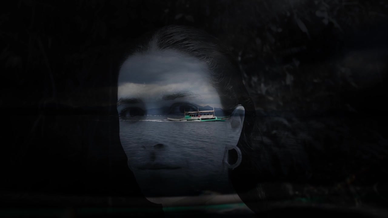 Artistic reflection of a woman’s face over a dark tropical boat scene in Palawan.