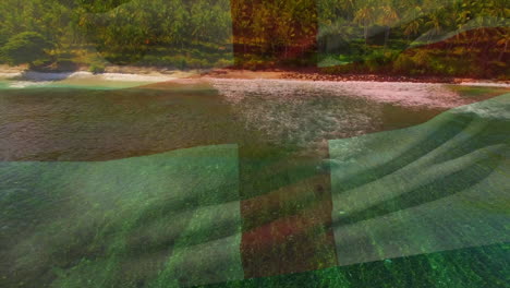 digital composition of waving england flag against aerial view of the beach and sea waves