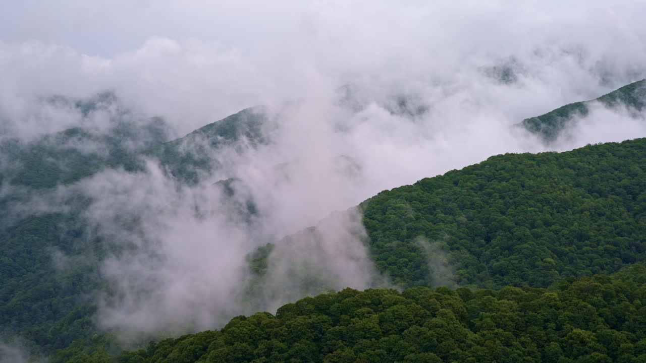 Aerial footage of the Smokies breathing mist and fog
