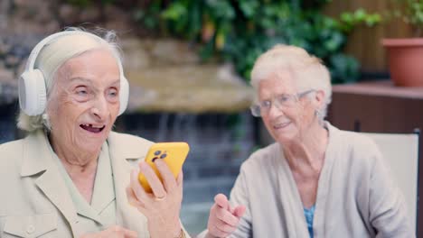 two elderly women using technology