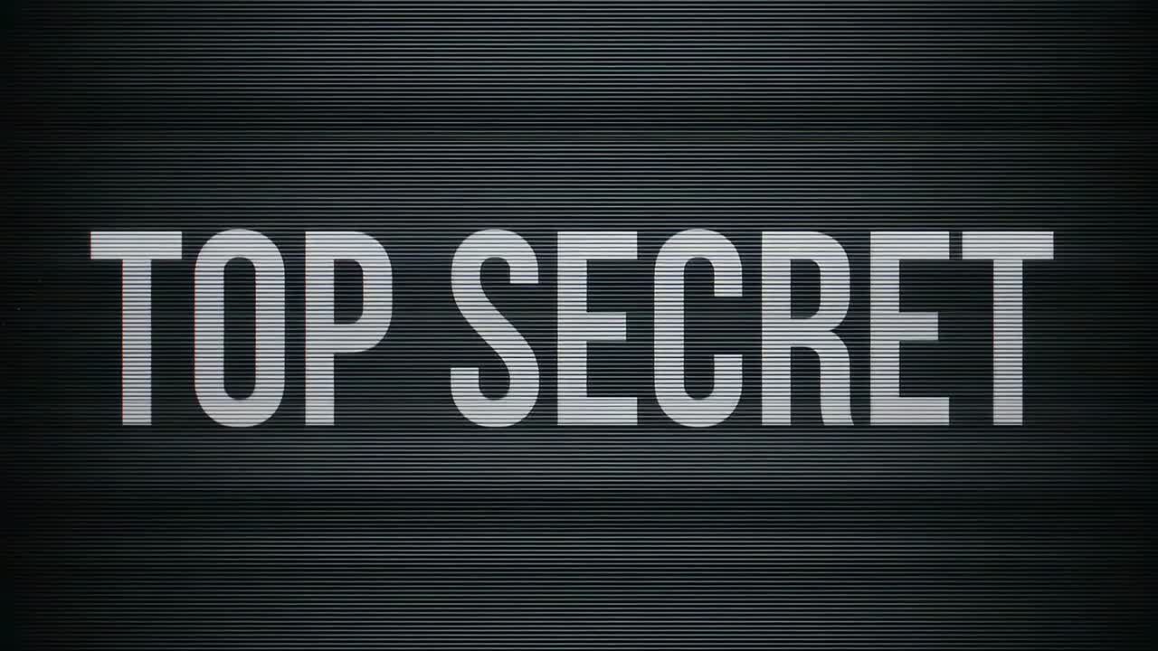Flickering centered TOP SECRET card on VHS as playback starts, showing scanlines, vignette, grain