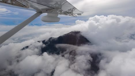 the top of the mountains can be seen above the thick clouds