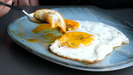 fried eggs with a spoon