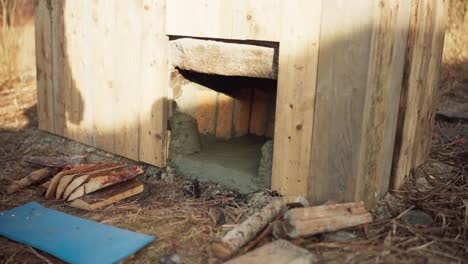 man preparing firewood for his diy hot tub outdoors - close up