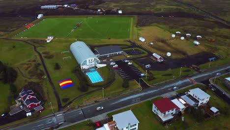 aerial view of a car driving at the small town of vogar in southwest iceland