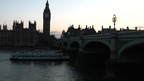 sailing on river thames nearby the house of parliament and big ben at sunset