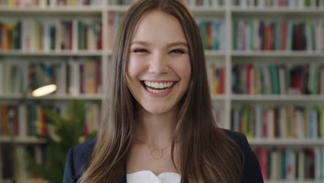 portrait-of-young-beautiful-woman-standing-in-library-student-smiling-laughing-study-learning