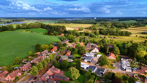 amazing rural area with lush greenery and cute low-rise residential houses. beautiful sky with stunning clouds at backdrop