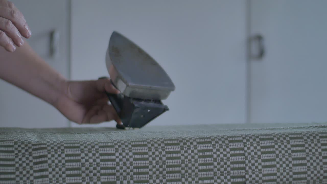 Man Smoothes the Fabric with an Old Vintage Iron-1