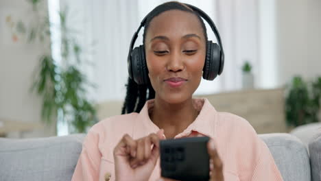 headphones, phone and young woman on a sofa