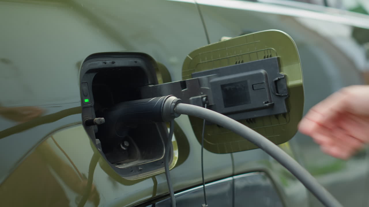 Driver Closing Battery Charging Port Flap Of Electric Car After Recharge