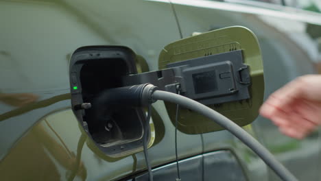 Driver Closing Battery Charging Port Flap Of Electric Car After Recharge
