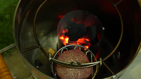 beef patty grilled in barrel for hamburger