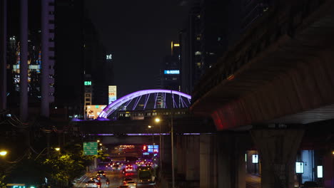 Busy-Elevated-Bangkok-BTS-Skytrain-System-at-Night-in-Finance-Central-Business-District,-Bangkok-Night-Time