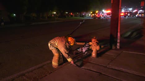 firefighter connecting hose to fire hydrant