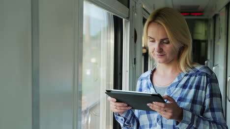 A-Young-Traveler-Uses-A-Tablet-In-The-Train-Car